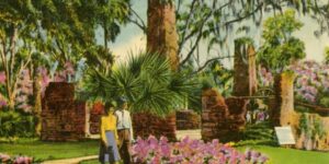 Vintage Florida postcard showing visitors strolling through lush gardens surrounding old sugar mill ruins, with blooming azaleas, palmettos, brick arches, and towering chimneys under draping Spanish moss. This romantic Old Florida setting reflects the historic landscapes that continue to shape Volusia County’s cultural heritage and inspire writers drawn to nature, memory, and place.