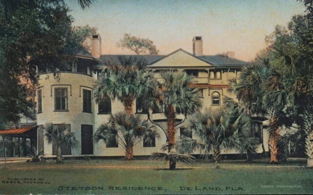Vintage postcard of the Stetson Mansion in DeLand, Florida, a large multi-story home surrounded by palms and shaded by mature live oaks. The elegant structure, built for hat magnate John B. Stetson, reflects the architectural and cultural legacy that helped establish DeLand as an influential center of education, philanthropy, and the arts. This landmark home embodies the historic character that continues to shape Volusia County’s literary and cultural identity.